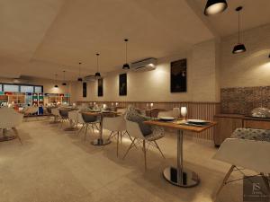 a restaurant with tables and chairs in a room at Zone by The Park New Market Kolkata in Kolkata