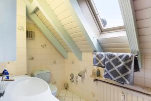 a bathroom with a toilet and a window at Cheng 2 in Baden-Baden +15 photos