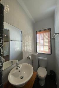 a bathroom with a sink and a toilet and a mirror at Norn-Nanta House in Chiang Mai +73 photos