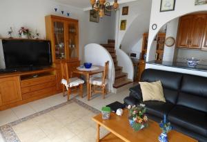 a living room with a couch and a table at Wonderful house with private beach in El Campello
