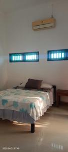 a bedroom with a bed with lights on the wall at Dewenten Backpacker II in Tulamben