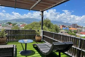 a patio with a table and chairs on a balcony at Norn-Nanta House in Chiang Mai
