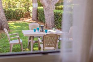a white table and chairs with drinks on it at Apartamento con estupenda terraza-a4 in Son Xoriguer +18 photos