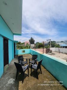 a table and chairs on the balcony of a building at Le homestay villa in Puducherry