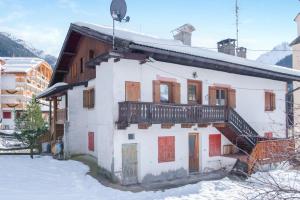 a house with a balcony on top of it in the snow at Cesa Crepaz in Canazei