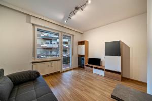 a living room with a couch and a television at Appartement Franziskus in Merano