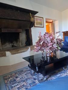 a living room with a table with flowers on it at B&B Il Rifugio della Felicità Civitella in Setri +30 photos