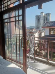 MengjiagangにあるZhangjiajie West Station Innのバルコニー(椅子付)が備わる客室です。