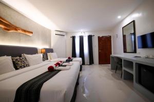 a hotel room with a large bed and a television at El Fuego Boracay in Boracay