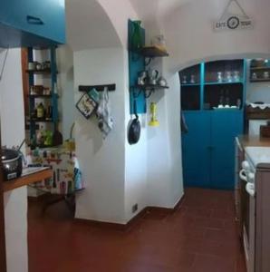 a kitchen with blue cabinets and a blue door at Le Monticelle in Itri +4 photos