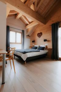 a bedroom with a large bed in a room with wooden ceilings at Germain Ski Lodge in La Toussuire