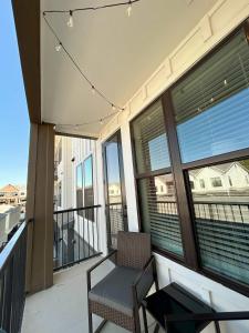 a balcony with a chair and a table and windows at Charming 1BR Retreat - Walk to Gruene Hall Upscale Amenities in Gruene +10 photos