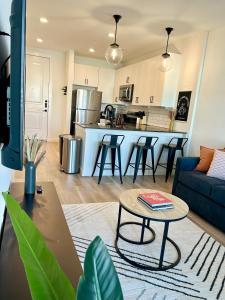 a living room and kitchen with a couch and a table at Charming 1BR Retreat - Walk to Gruene Hall Upscale Amenities in Gruene