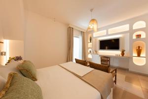 a hotel room with two beds and a desk at Ostuni a Mare in Ostuni