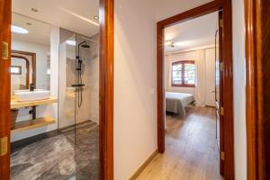 a bathroom with a glass shower and a sink at Callao in Playa Honda +22 photos