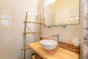 a bathroom with a white bowl sink on a wooden counter at Nikos Seaside studio 3 in Agia Pelagia Chlomou