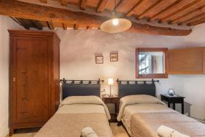 a bedroom with two beds in a room at Cal Torrentí in Caserras +28 photos