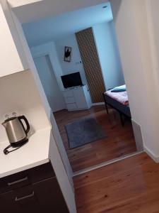 a view of a room with a bed and a kitchen at Stellas Monteurwohnung in Crimmitschau +4 photos