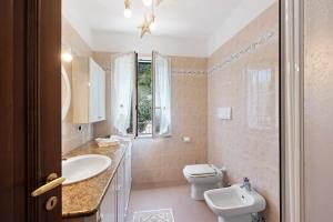 a bathroom with a white toilet and a sink at Bagetti in Varazze +16 photos