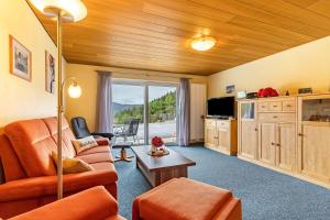 a living room with a couch and a table at Ferienwohnung Berghansenhof in Wolfach