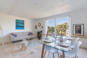 a living room with a table and chairs and a couch at La Bastidonne in La Bastidonne