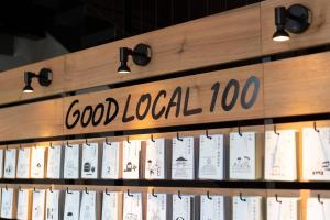 a shelf of books with a sign that reads good local at hotel around TAKAYAMA, an Ascend Collection Hotel in Takayama