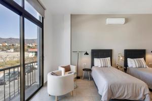 a bedroom with two beds and a balcony at Urban Park Girasol in Los Llanos de Aridane