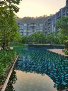 une grande piscine en face d'un bâtiment dans l'établissement The Valley Escape สองห้องนอน สวย สงบ สบาย, à Phayayen