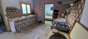 a kitchen with a stove and a counter top at Wohnung bei Guia de Isora auf Finca Los Meneses in Guía de Isora +29 photos