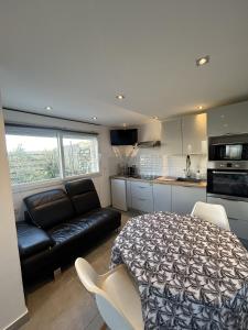 a bedroom with a bed and a couch in a kitchen at Petit Duplex Proche Mer in Plouhinec +18 photos