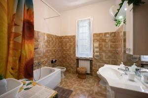 a bathroom with a sink and a tub and a toilet at I Girasoli in Alassio +18 photos