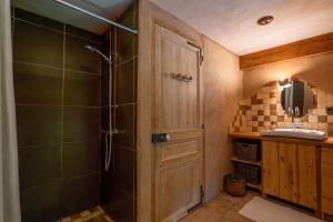 a bathroom with a shower with a glass door at Gîte Écologique - Le Nid des Anges in Saint-André-Lachamp