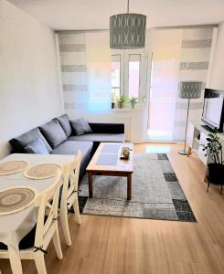 a living room with a couch and a table at Schönes Apartment In Walschleben in Walschleben