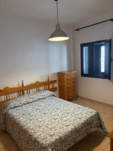 a bedroom with a bed and a dresser and a window at Copenhagen Lovely in Gran Tarajal