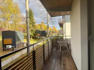 a balcony with a view of a train yard at Apartmán Forest, Tatranská Štrba in Tatranska Strba +2 photos