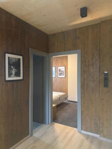 a bedroom with a bed in a room with wooden walls at Apartmán Forest, Tatranská Štrba in Tatranska Strba