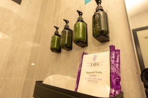 a wall with four green lights on a wall at استوديو فاخر بتصميم عصري in Riyadh +21 photos