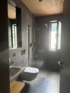 a bathroom with a toilet and a sink and a shower at Apartmán Forest, Tatranská Štrba in Tatranska Strba