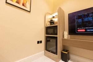 a room with a flat screen tv on a wall at استوديو فاخر بتصميم عصري in Riyadh