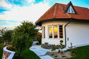a white house with a red roof at Villa Mira in Mačkat
