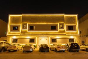 a building with cars parked in a parking lot at night at استوديو فاخر بتصميم عصري in Riyadh
