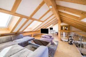 a living room with a couch and a tv at Maisonettewohnung am Wössener See in Unterwössen