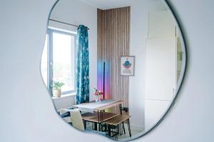 a dining room with a table and a mirror at Propti in Manchester