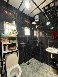 a bathroom with a toilet and a sink at The K Residence in Kampala