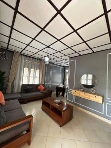 a living room with a couch and a table at The K Residence in Kampala