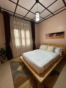 a bedroom with a large bed with a wooden frame at The K Residence in Kampala +12 photos