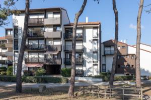 an apartment building with trees in front of it at Studio Seignosse proche plage in Seignosse