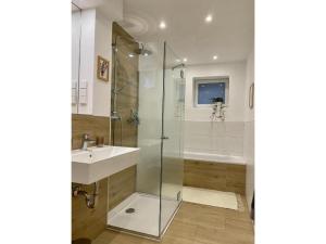 a bathroom with a glass shower and a sink at Die Raspel in Melsungen