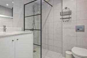 a bathroom with a shower and a toilet and a sink at Helios Apartment 2 in Karpathos Town