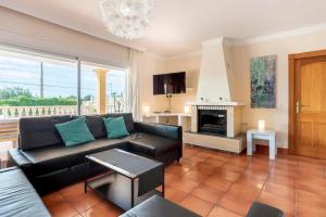 a living room with a couch and a fireplace at Can Pedra junto a Playa den Bossa in Sant Jordi